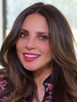 Smiling woman with long brown hair and bright pink lipstick.