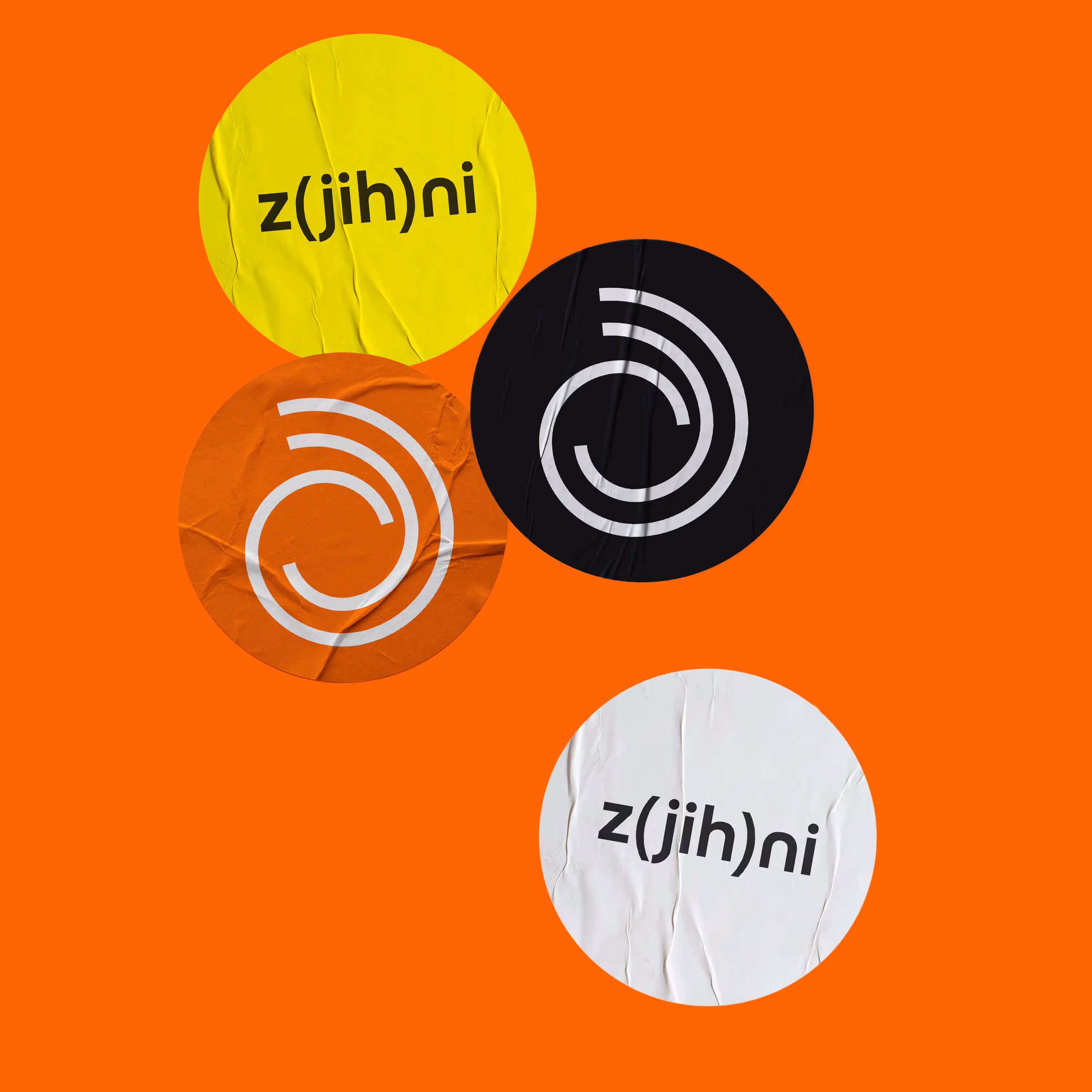 Four colorful round stickers on orange background, two say z(jih)ni, two have spiral symbols.