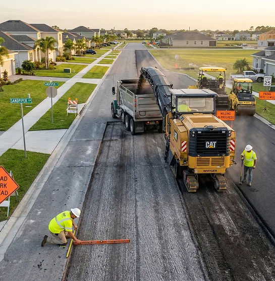 Asphalt milling and overlay crew preparing residential street for new pavement
