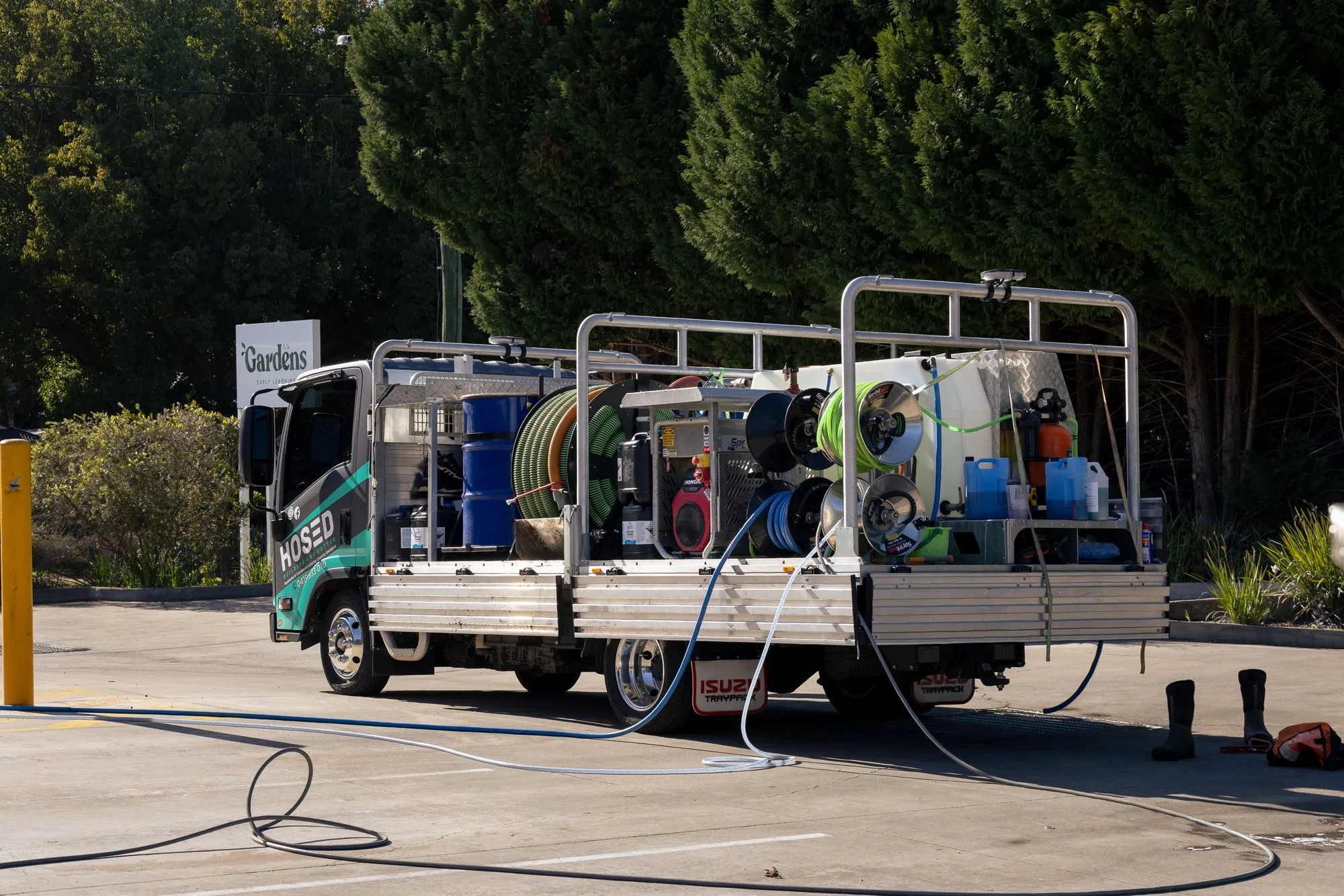 Hosed Building and Gutter pressure washing truck with professional exterior cleaning equipment ready for residential and commercial services
