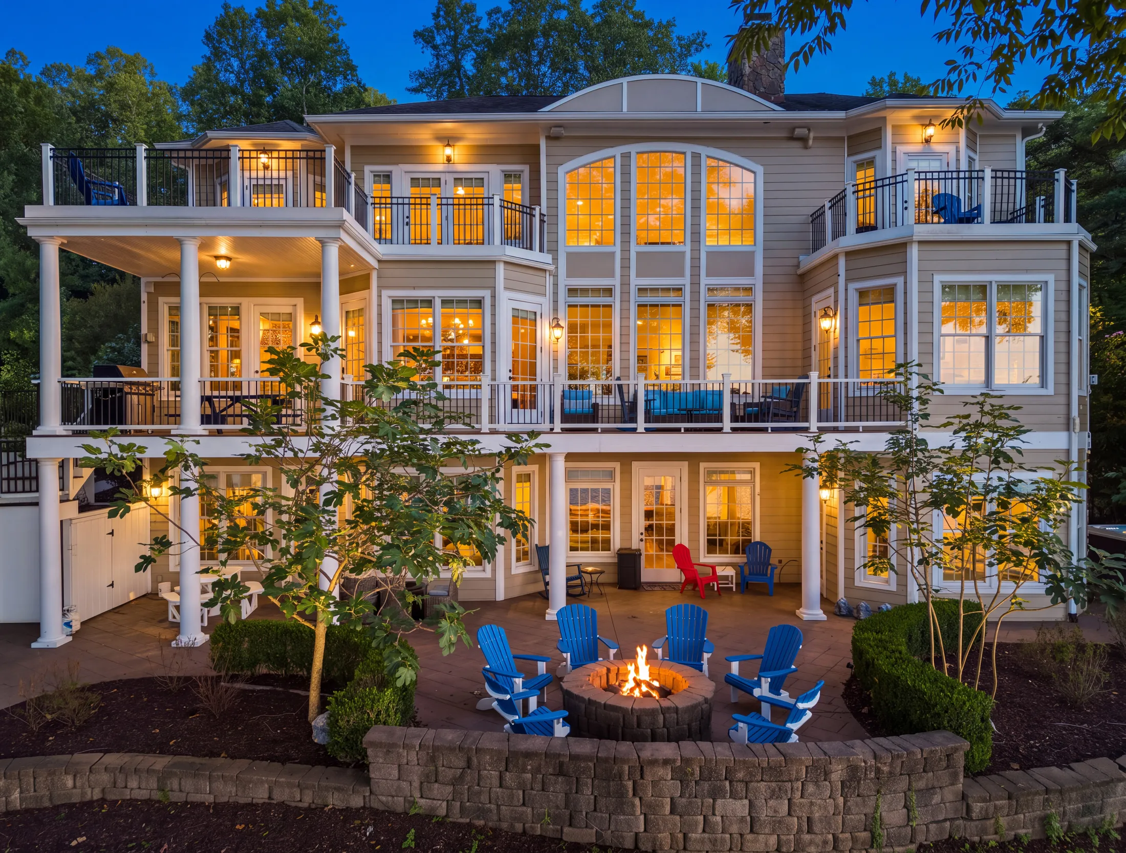 Lakefront home illuminated at twilight