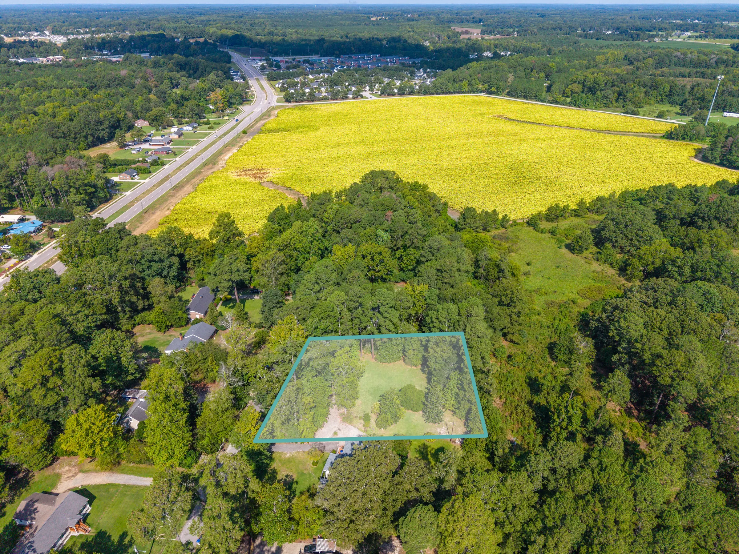 Aerial property photo with an approximate highlighted lot boundary used as a marketing reference.