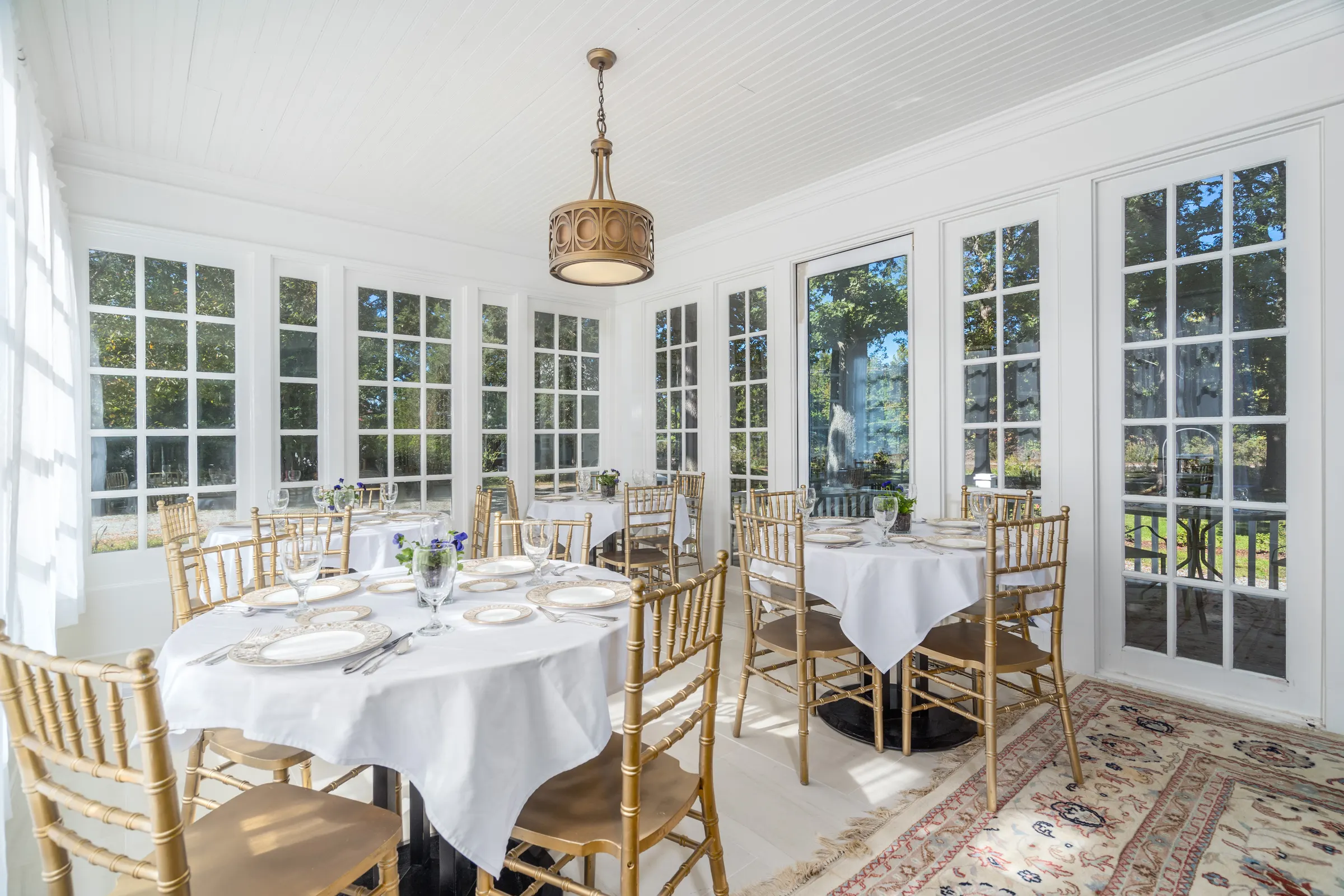 Bright hospitality event space with large windows and room for gatherings
