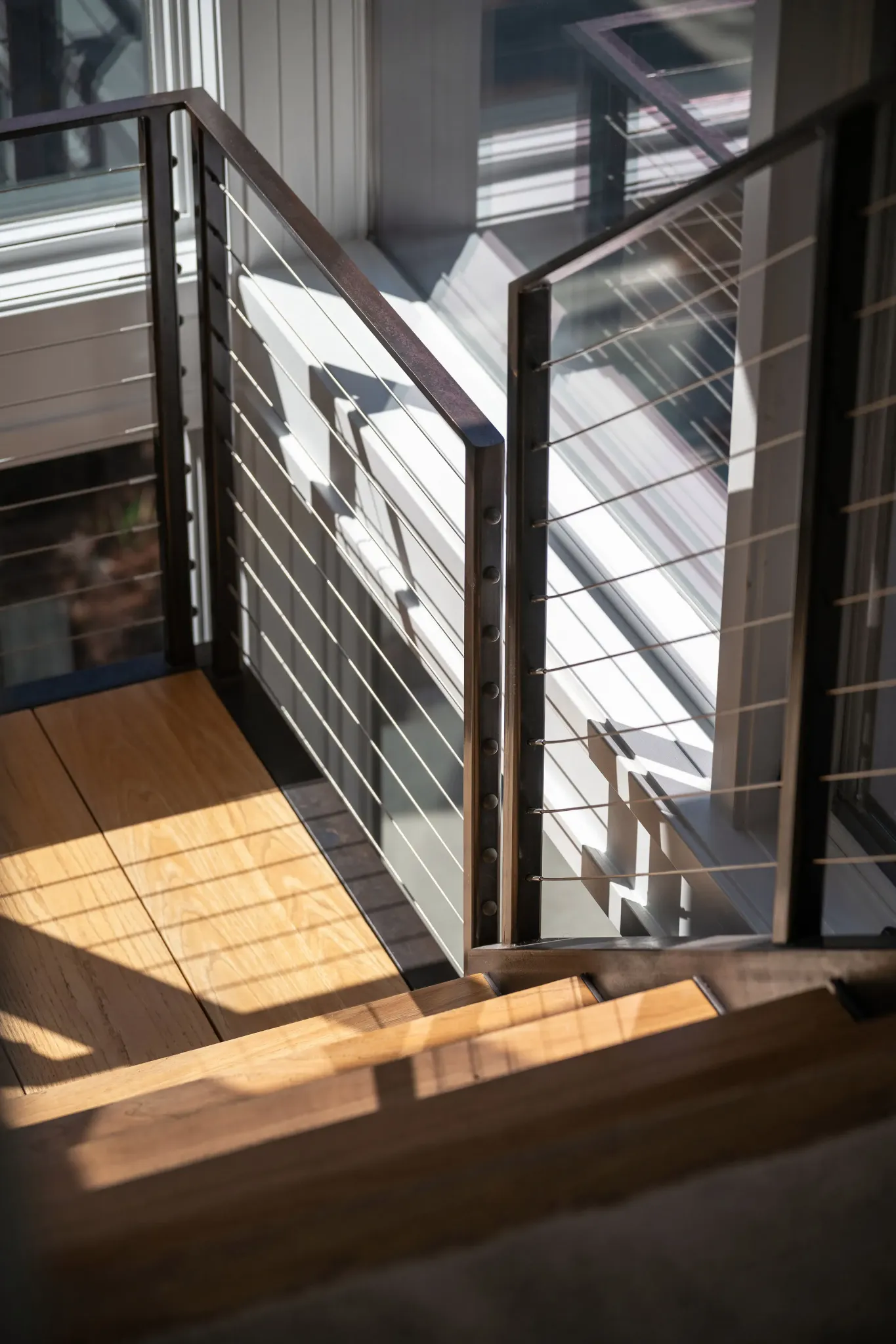 Stair railing and light shaping the interior