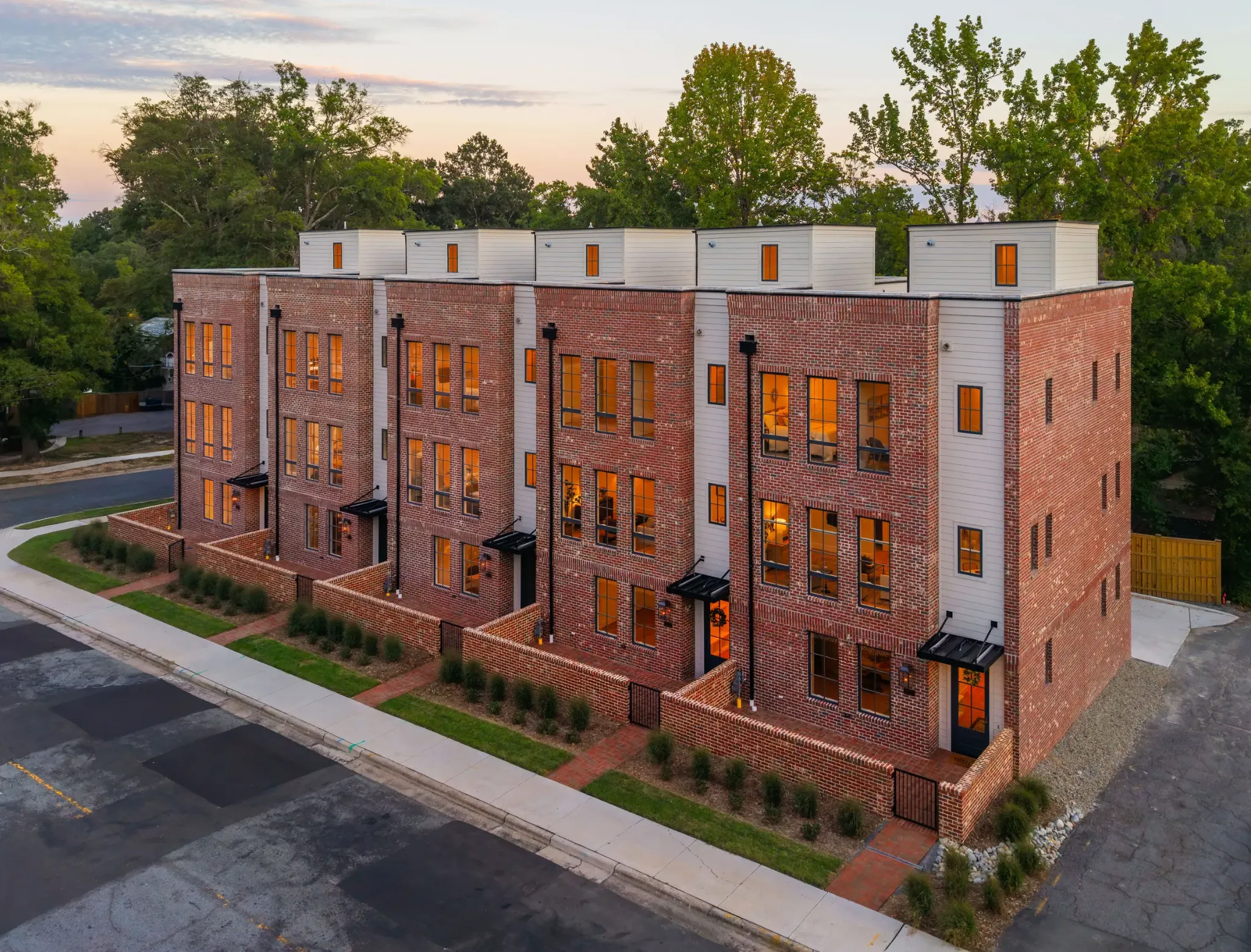 Aerial view of brick townhomes and their surrounding streets