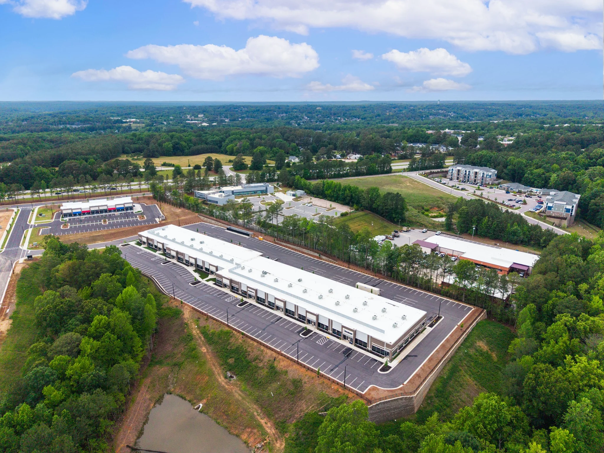 Commercial development with surrounding roads, parking, and neighboring properties