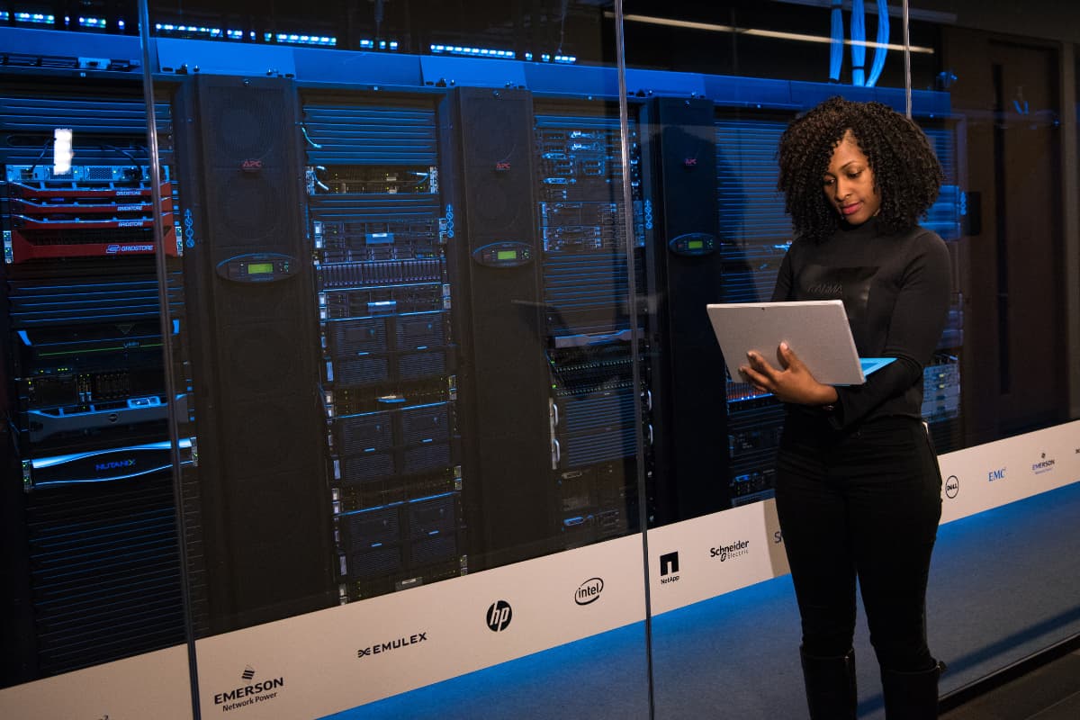 Woman checking backups for business in server room