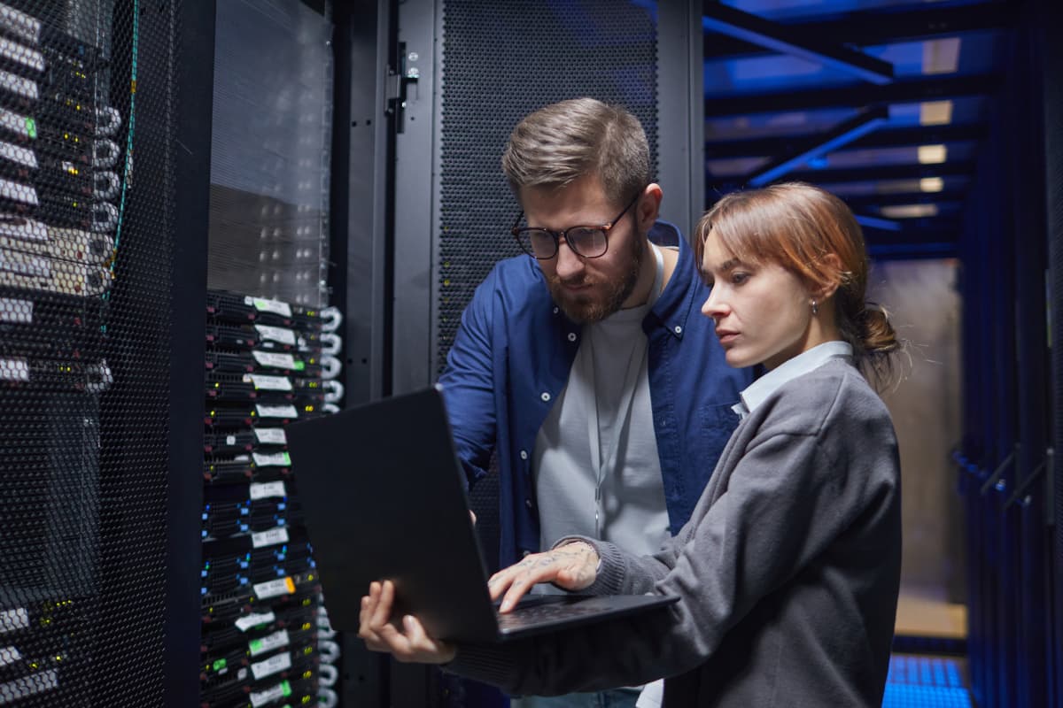 IT professionals checking health of network in server room