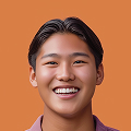 Smiling young man with short dark hair against an orange background.