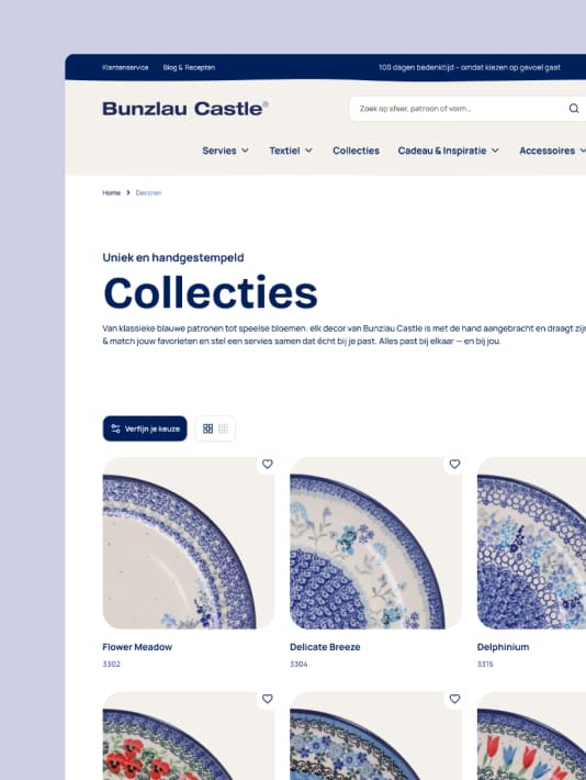 Bunzlau Castle website displaying ceramic collections with blue floral pattern plates and names.