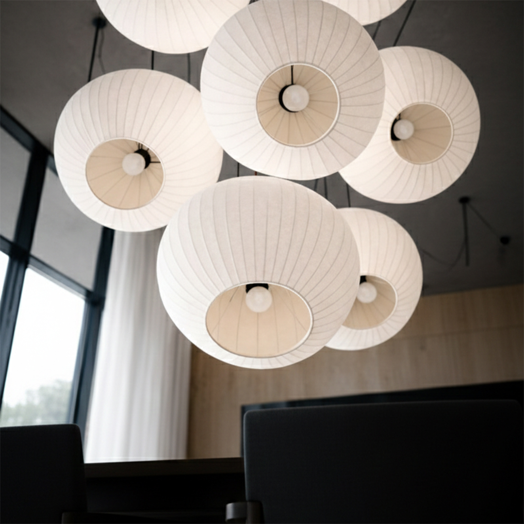 An upward-facing close-up showing the textured fabric and internal bulbs of the ribbed globe pendant lights.