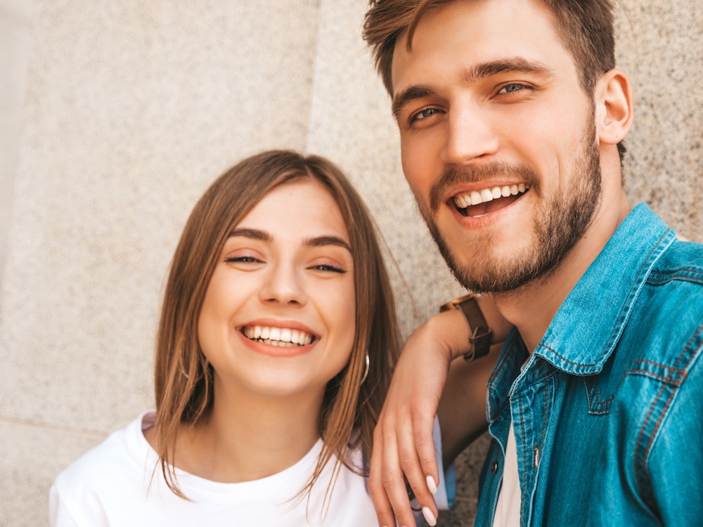 A man and a woman are smiling for the camera.