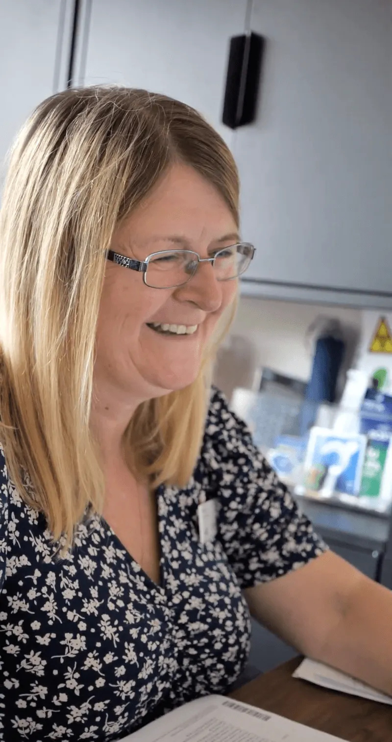 A woman sitting at a desk using a computer