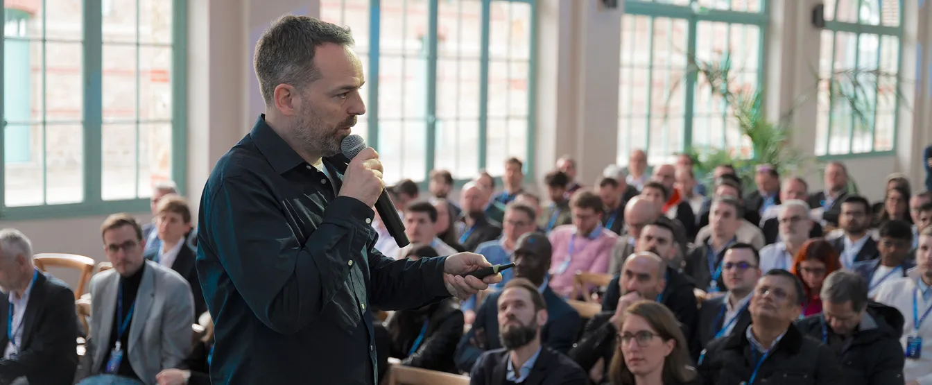 Man speaking at a public event or conference