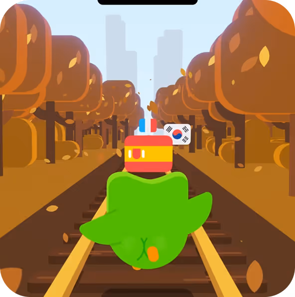 Cartoon green bird with orange feet running on train tracks towards a red train with the South Korean flag set against autumn trees.