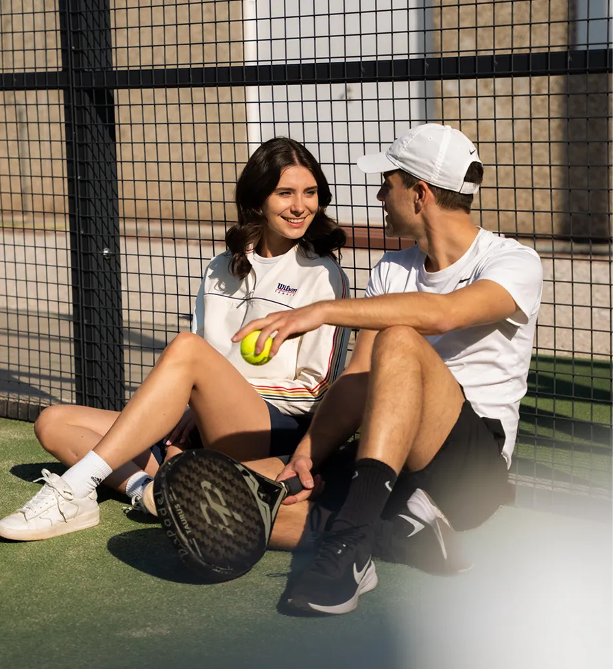 A man and a woman on a padel court