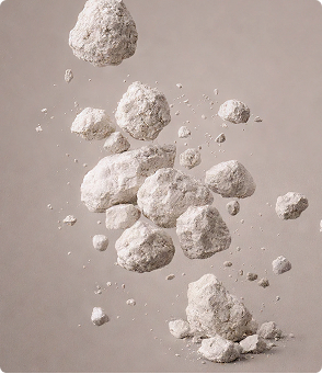 Clusters of white powdery lime particles floating against a neutral background.