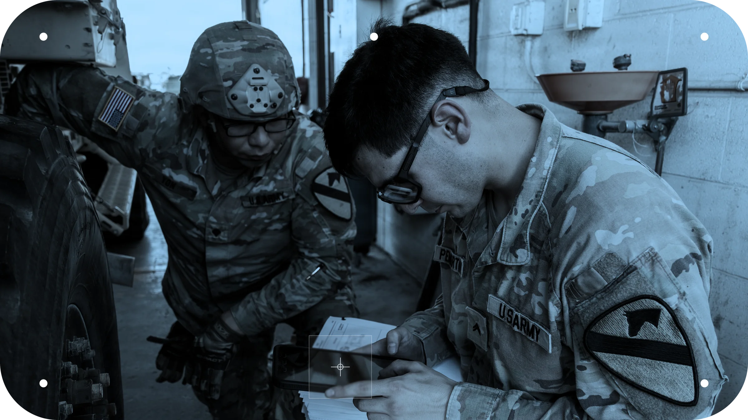 Two 1st Cavalry Division troopers review a maintenance checklist on a tablet beside a vehicle. U.S. Army photo by Staff Sgt. Zelika Stewart