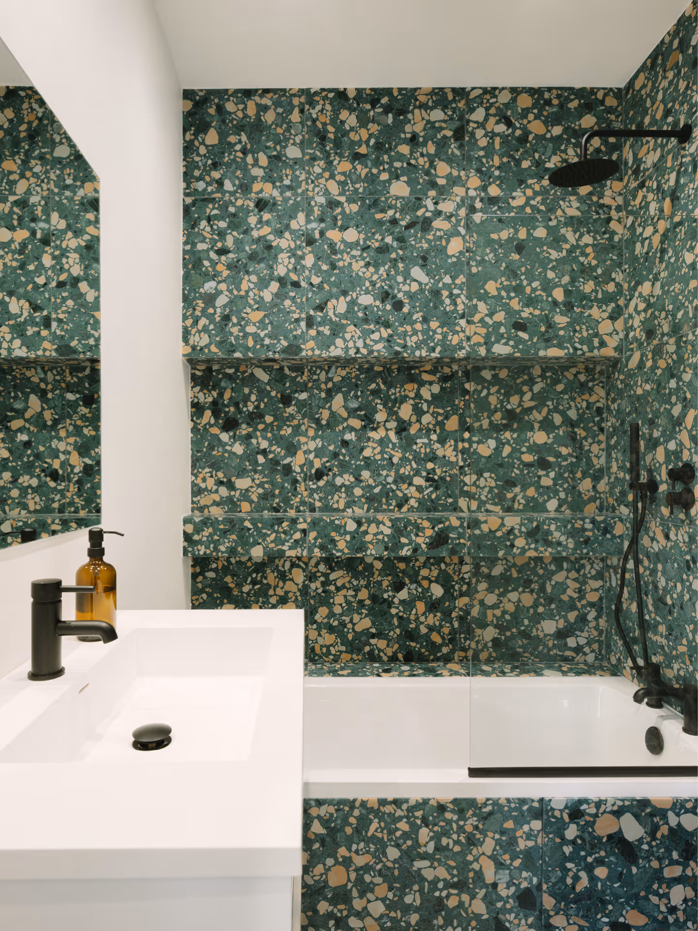 BOLD BATHROOM DESIGN | Featuring vibrant green terrazzo tiles paired with matte black fixtures, showcasing the refined detailing and material richness.