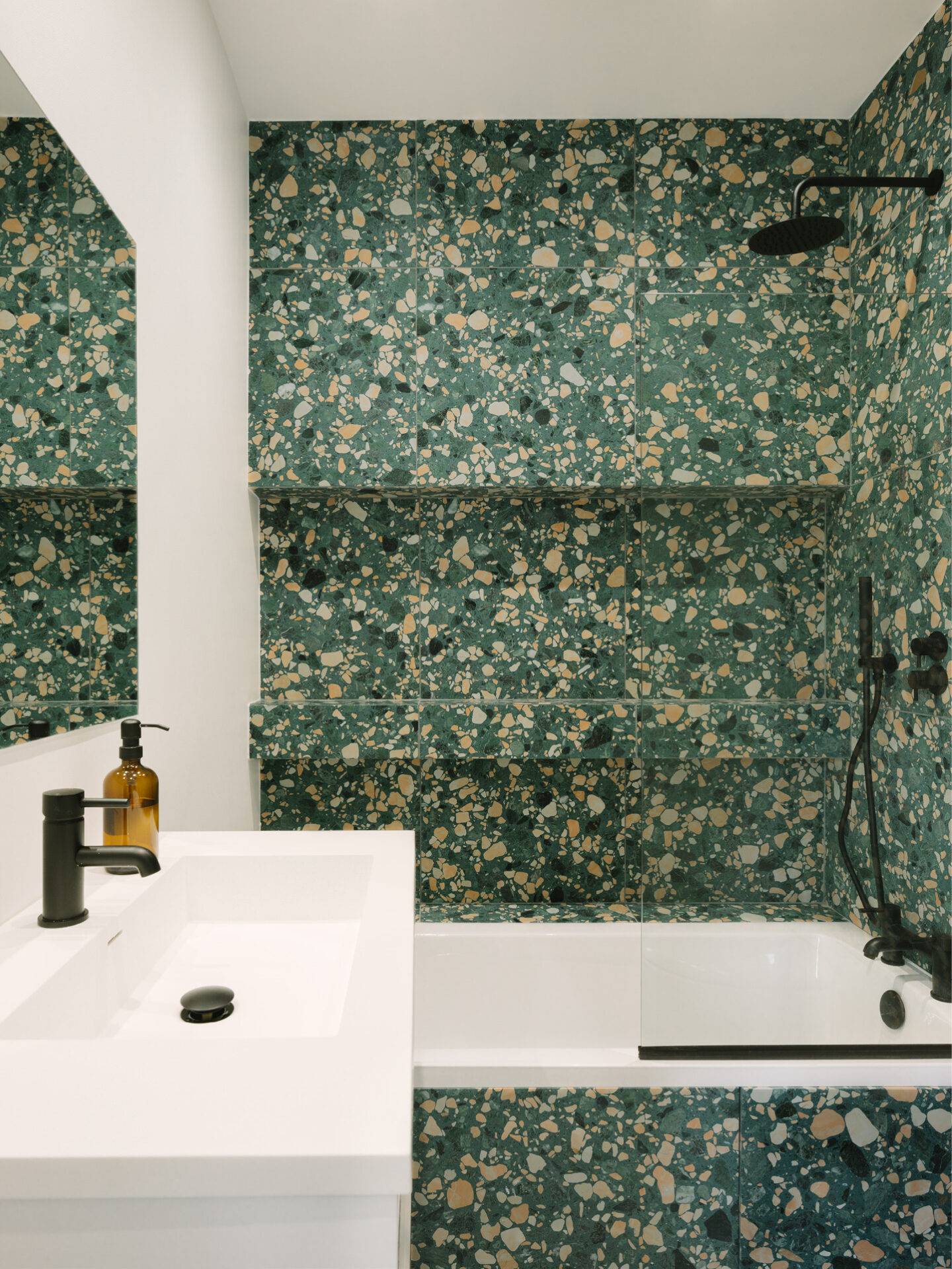 BOLD BATHROOM DESIGN | Featuring vibrant green terrazzo tiles paired with matte black fixtures, showcasing the refined detailing and material richness.
