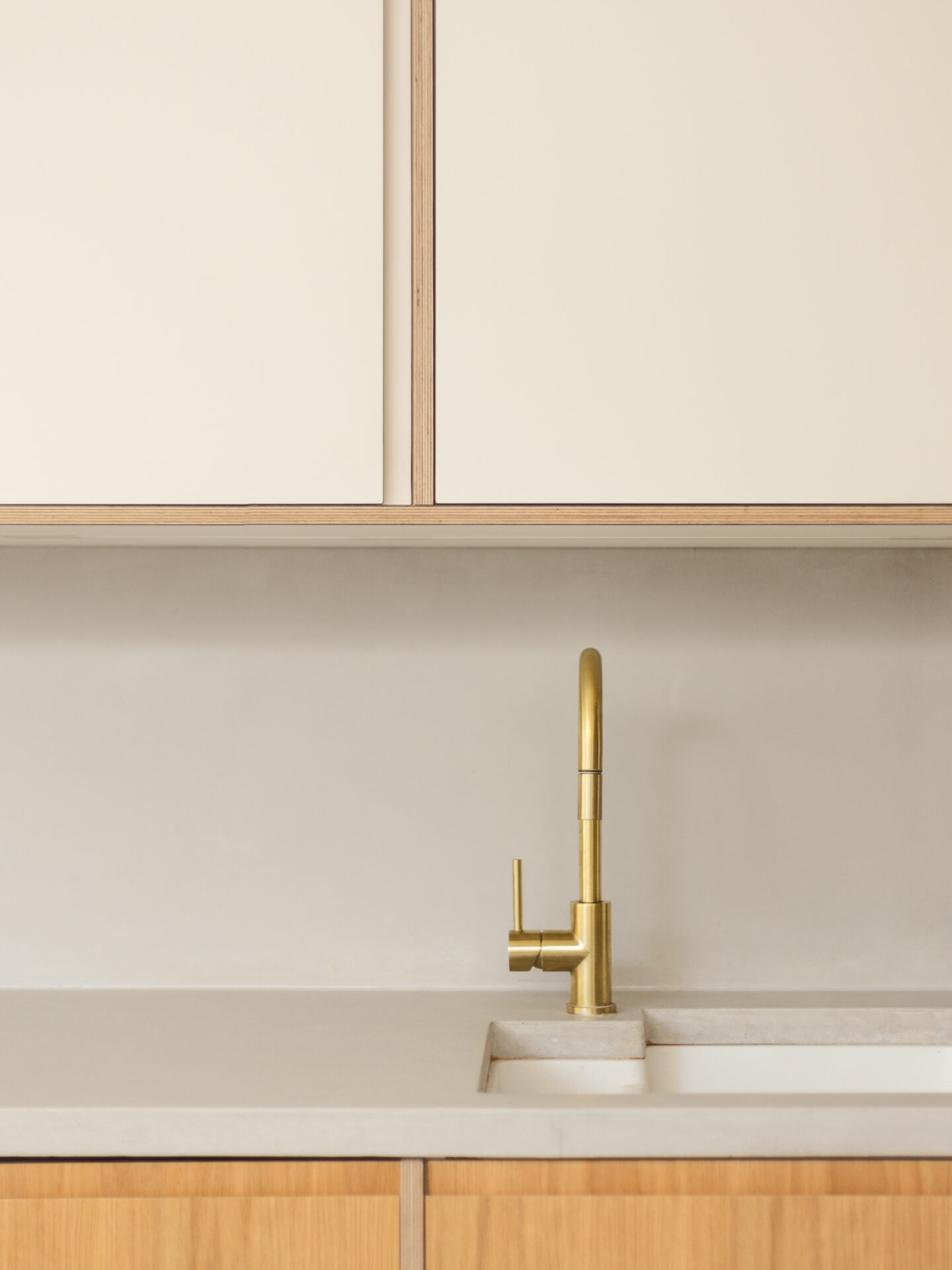 Material harmony | Brushed brass tapware with timber and muted stone finishes, creating a refined and enduring kitchen aesthetic