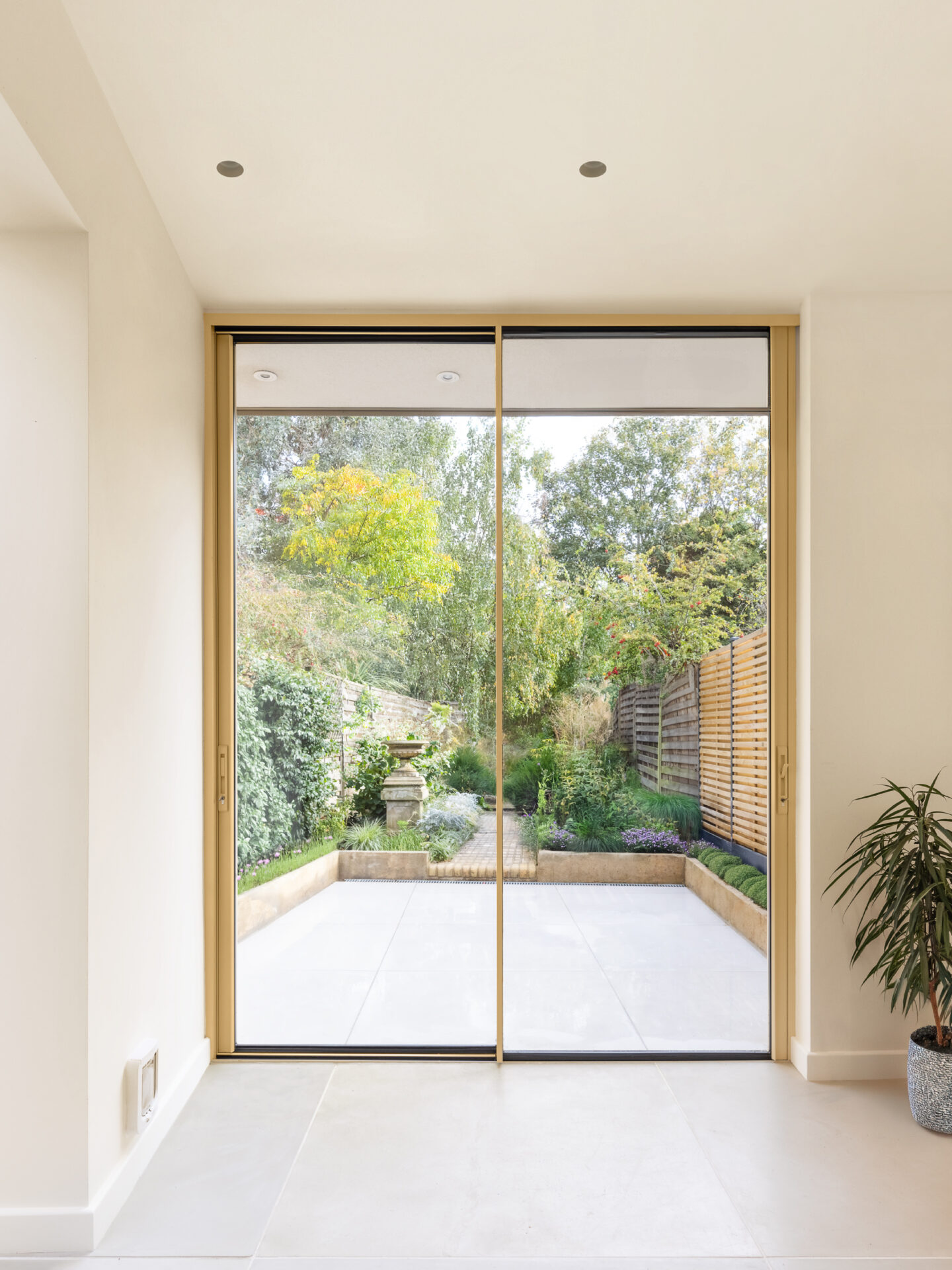 A new perspective | Kitchen interior view overlooking the newly landscaped rear garden through expansive glazing.