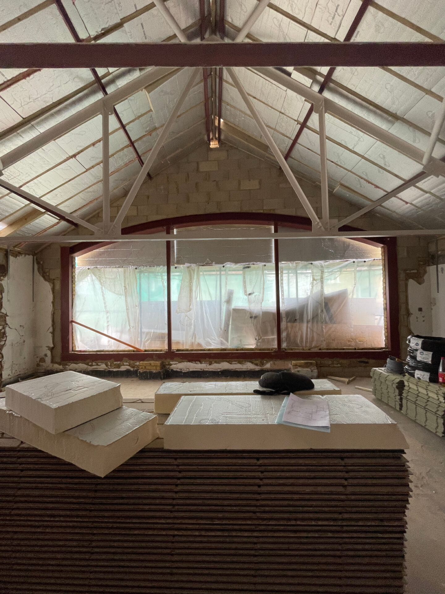 WORK IN PROGRESS | Exposed roof trusses and expansive window opening for an abundance of natural light to flow into living spaces.