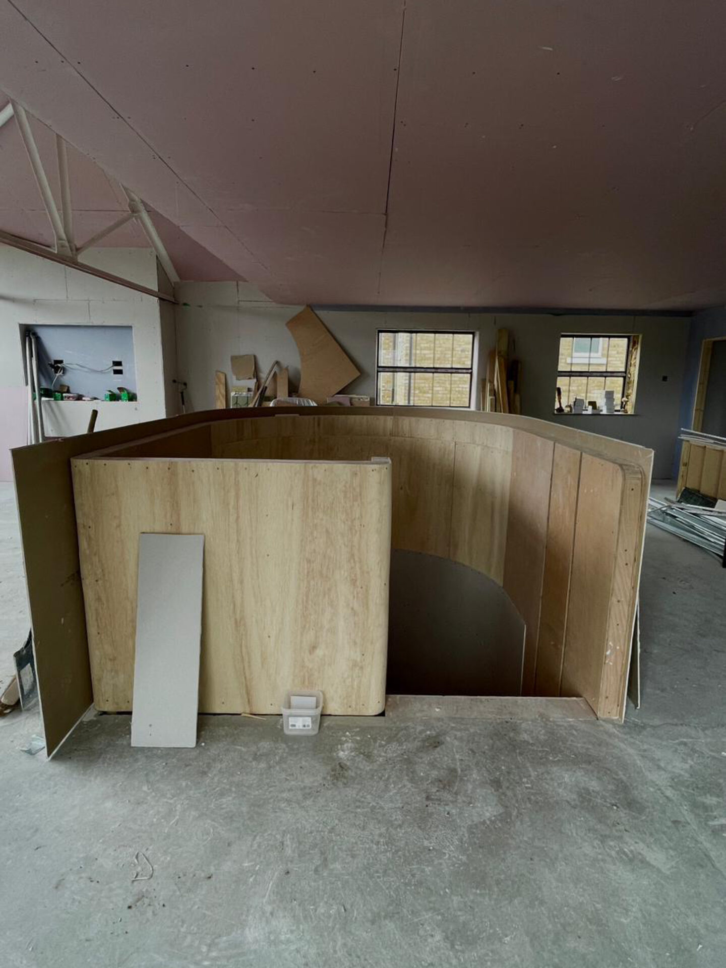 FORMING THE CURVED STAIRCASE CORE | The emerging timber framework of the circular staircase begins to take shape, establishing a central sculptural feature that will connect the home’s levels with fluidity and elegance.