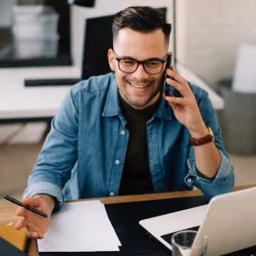 Marketing male, chatting on the phone in an office environment