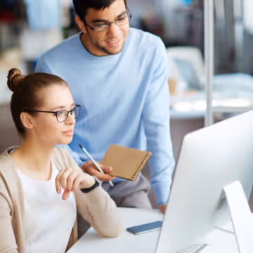 two work colleagues looking at computer screen