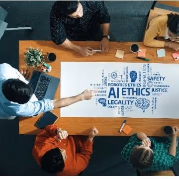 Colleagues discussing AI ethics around a table