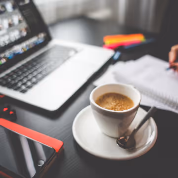 coffee and open laptop on a desk