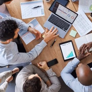 Overhead view of Marketers discussing a campaign