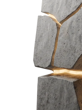 Close-up of large gray concrete blocks with illuminated cracks between them against a black background.