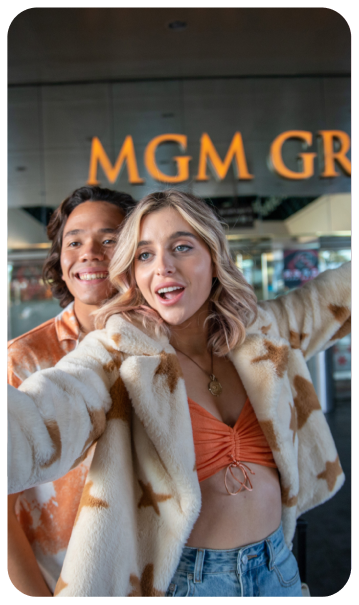 Exterior of MGM Grand Casino in Las Vegas, featuring a couple taking a selfie.