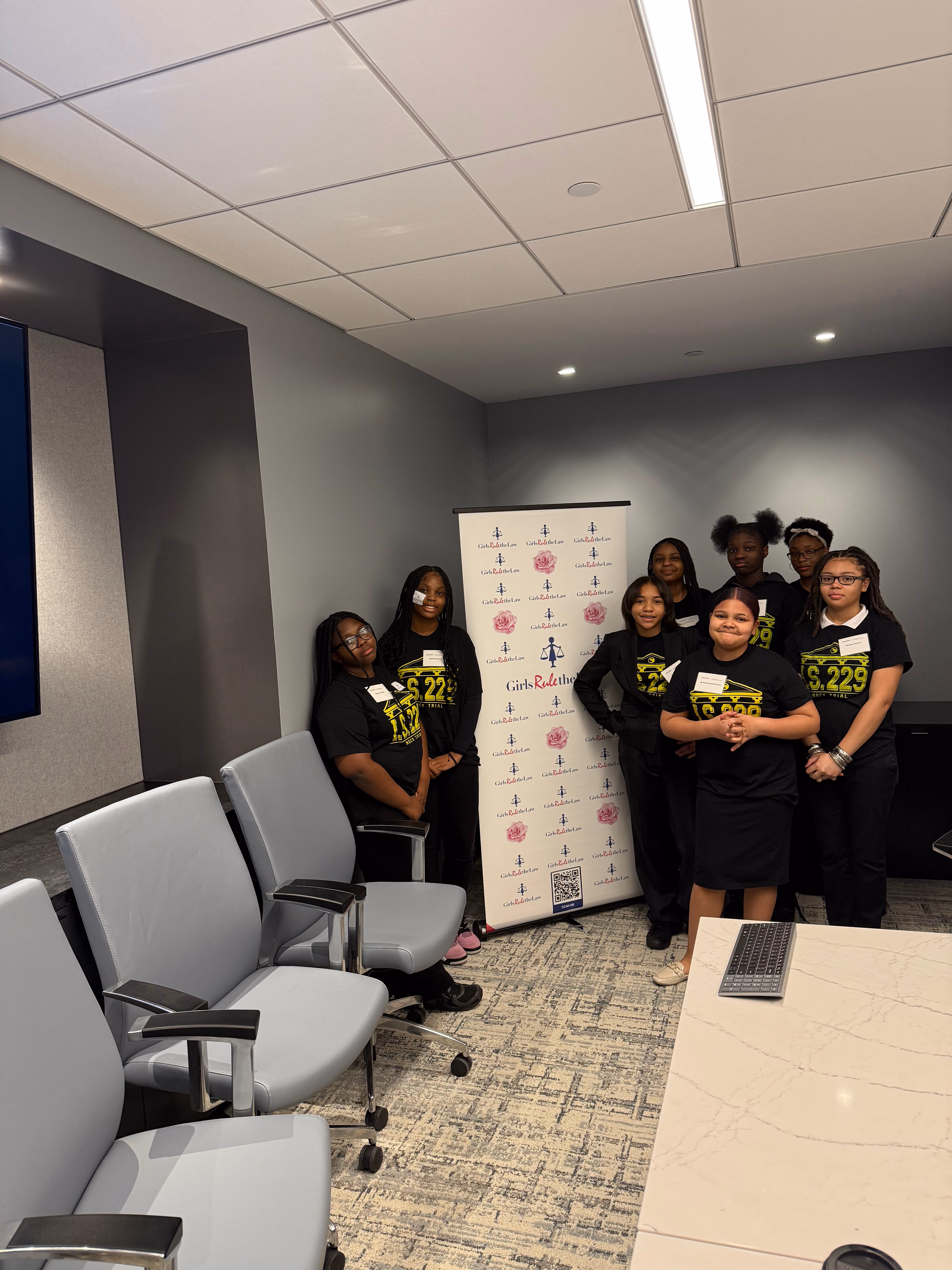 Students in matching black shirts posing at Girls Rule event