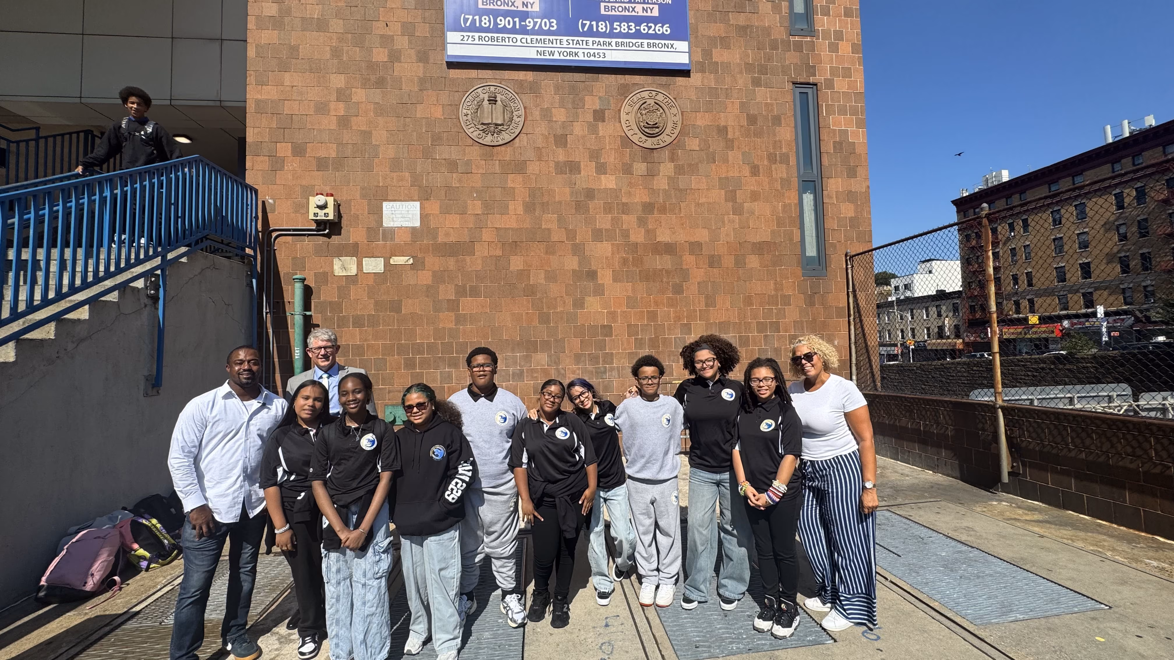 Students and staff posing outside a Bronx government building