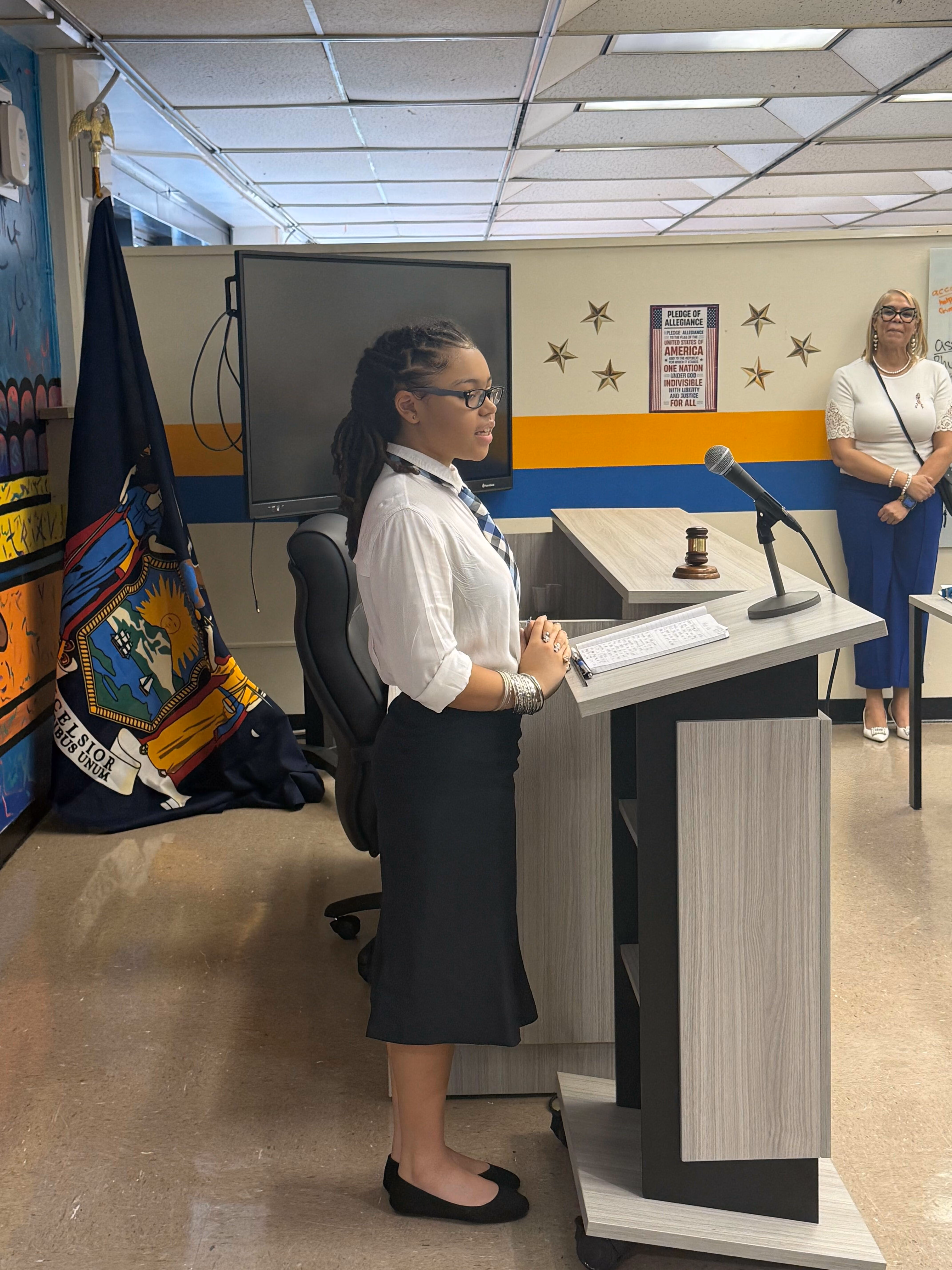 Student speaking at podium during school government presentation