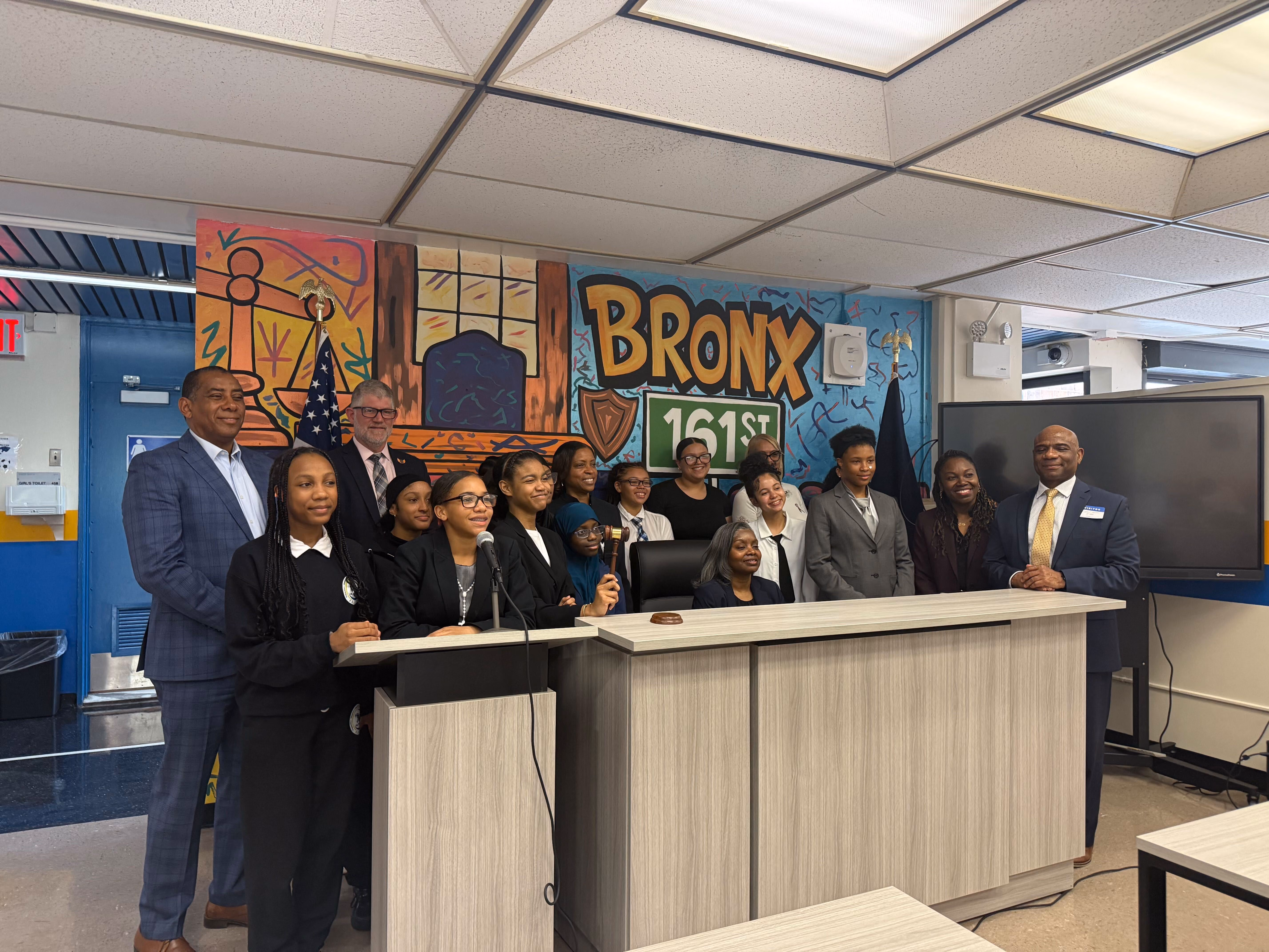 Students and adults pose in Bronx school mock courtroom