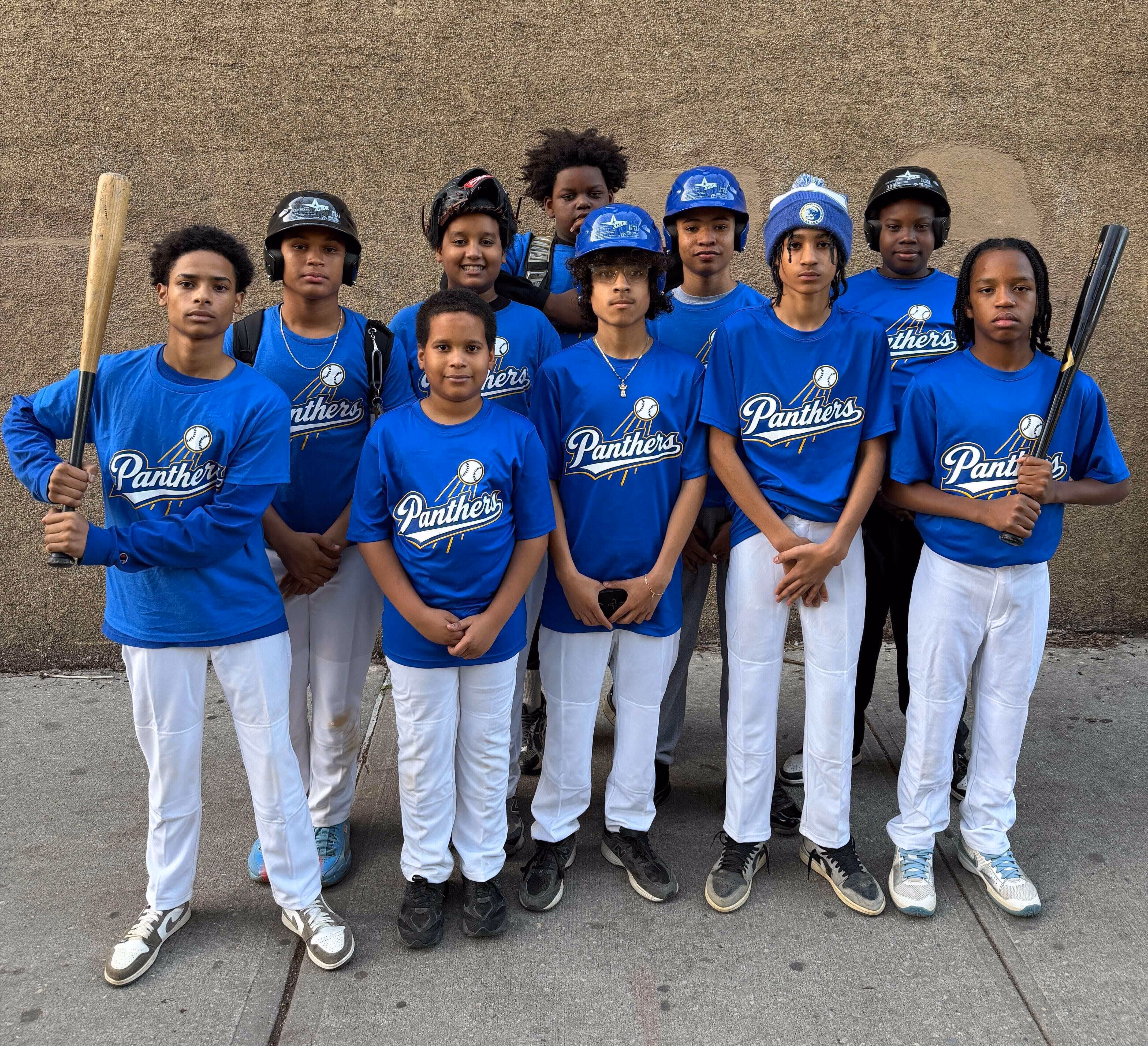 Panthers youth baseball team players posing together in blue uniforms