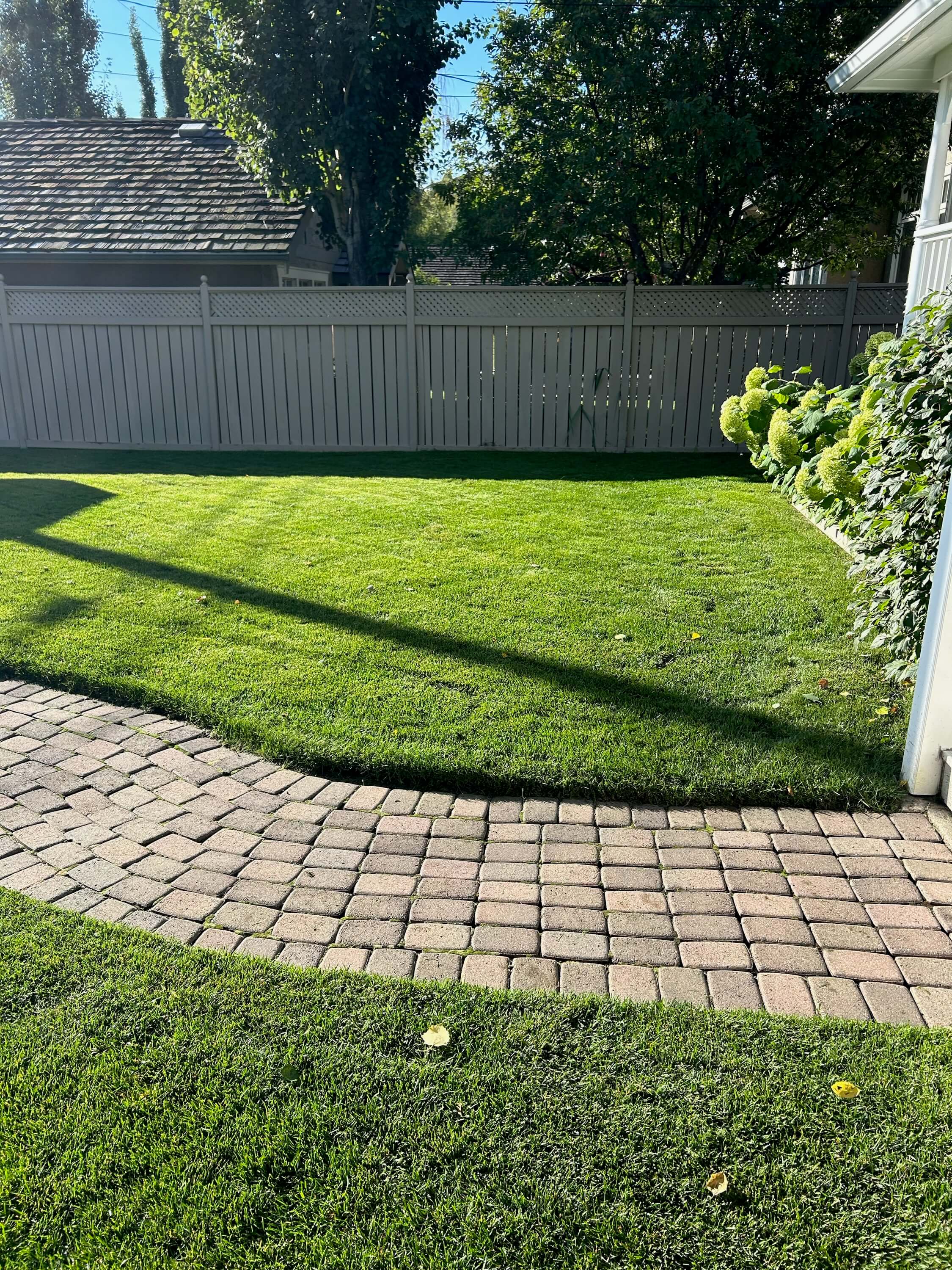 A well manicured yard pictured after service from Elite Yards Landscaping in Calgary, Alberta.