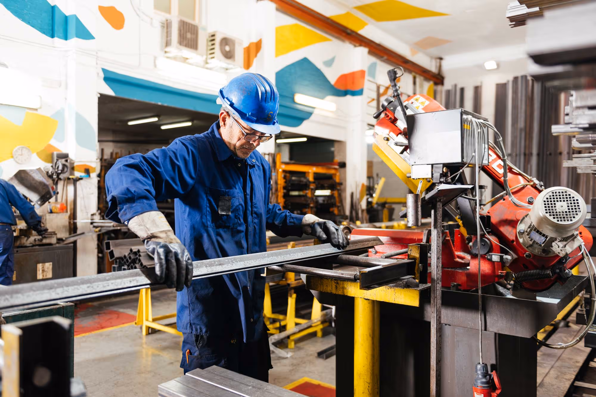 male-worker-working-in-workshop-at-factory-with-metal