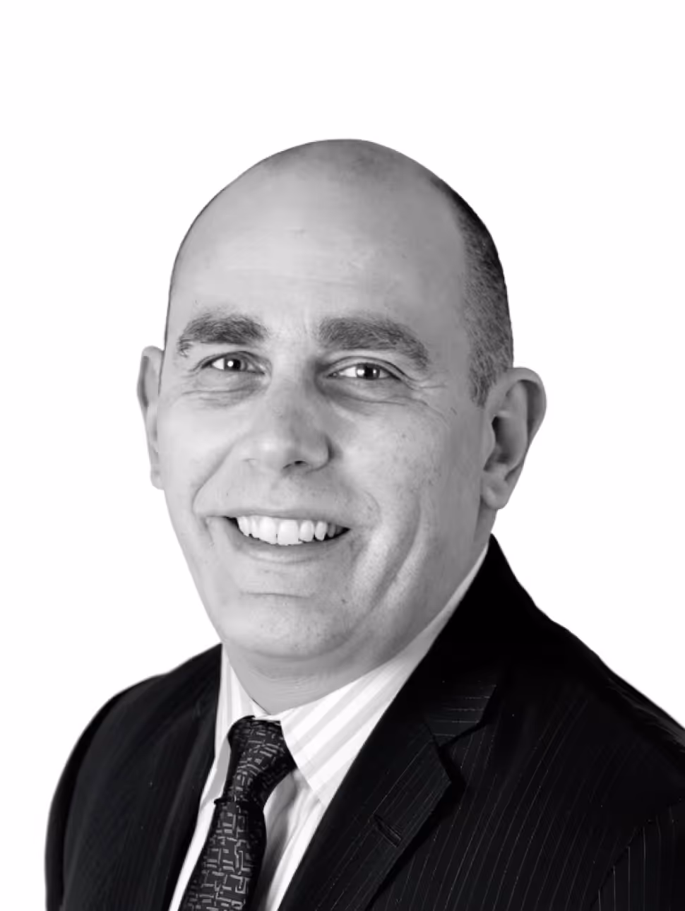 Smiling bald man wearing a dark suit, striped shirt, and patterned tie against a white background.