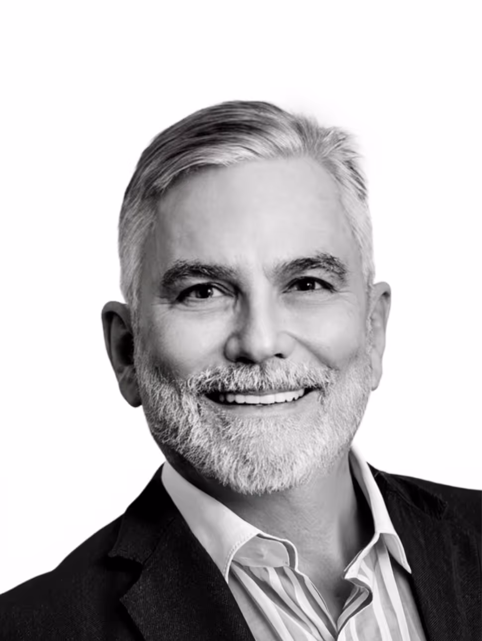 Smiling middle-aged man with gray hair and beard wearing a striped shirt and dark blazer.