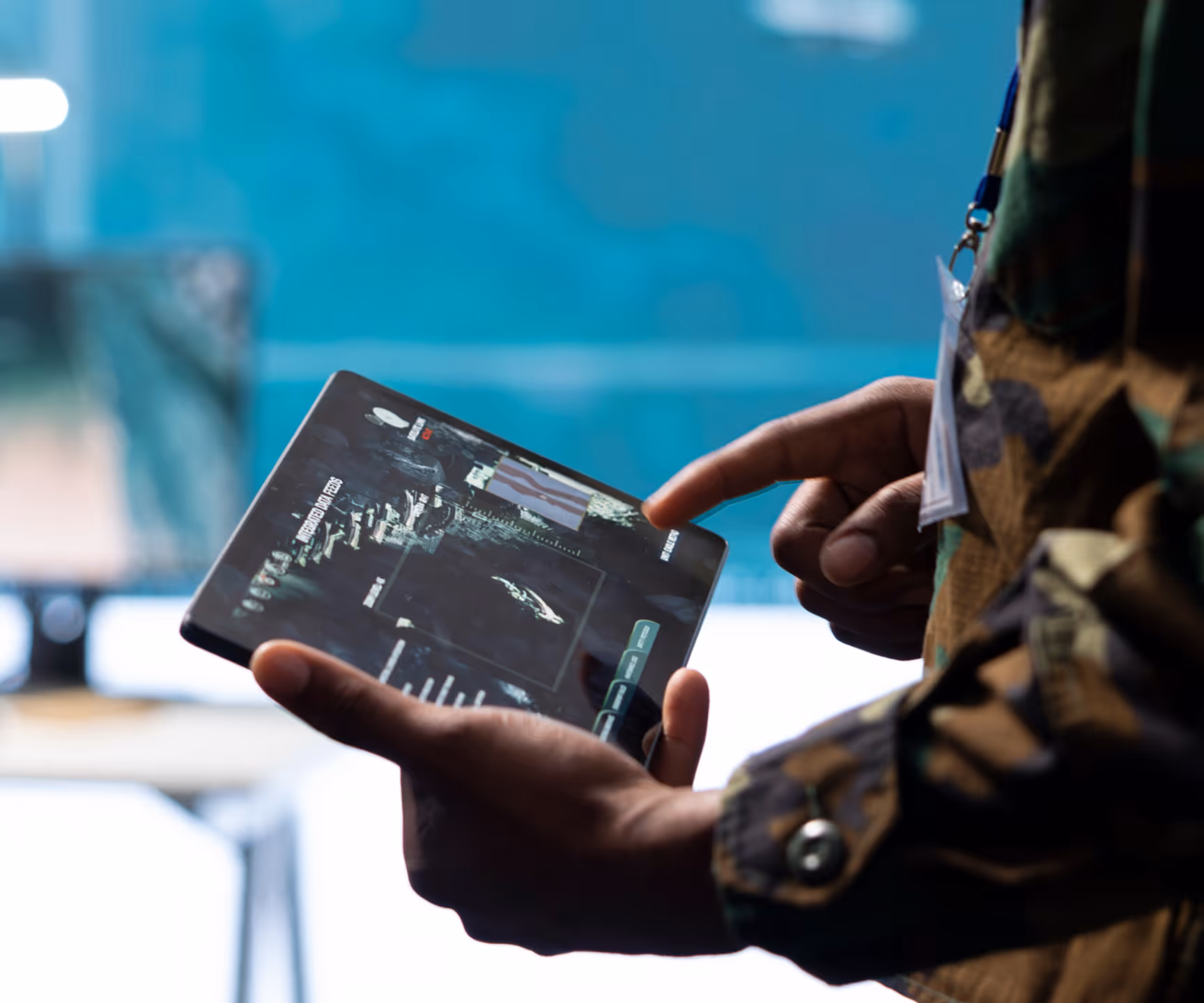 Soldier using a tablet for tactical operations.