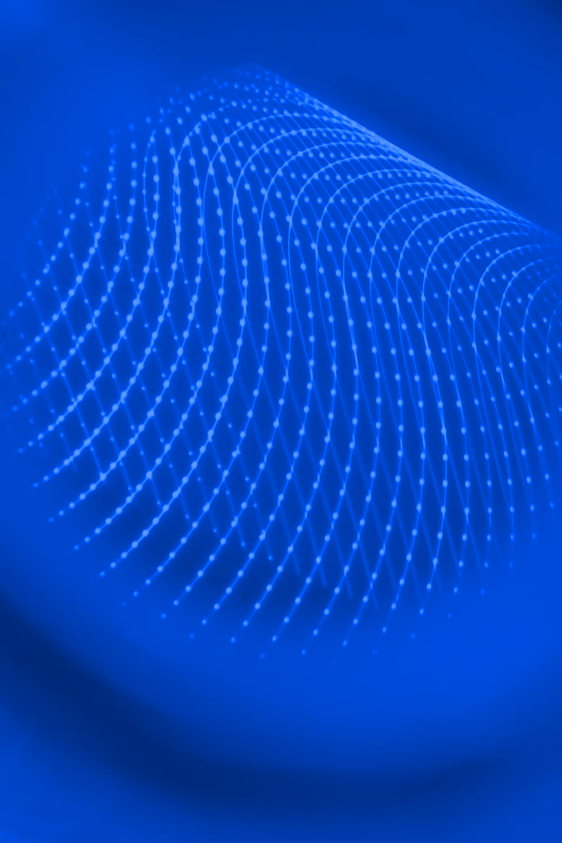 Shiny smooth sphere with a gradient glow on a blue background with subtle wavy grid patterns.