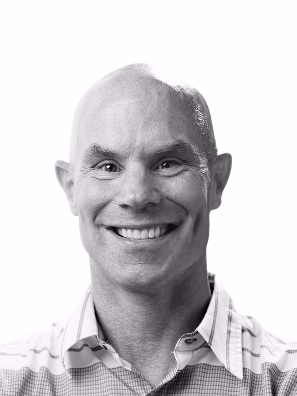 Smiling bald man wearing a checkered shirt against a white background.