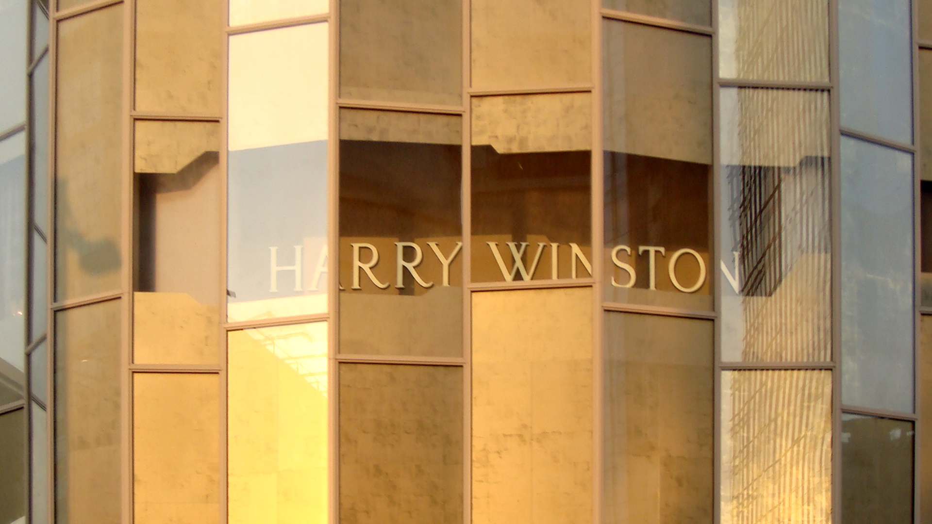 For Harry Winston we developed a gold agglomerate pattern that moved from hand-made studio tests into a screen-printed design, printed onto glass and installed across the store windows.