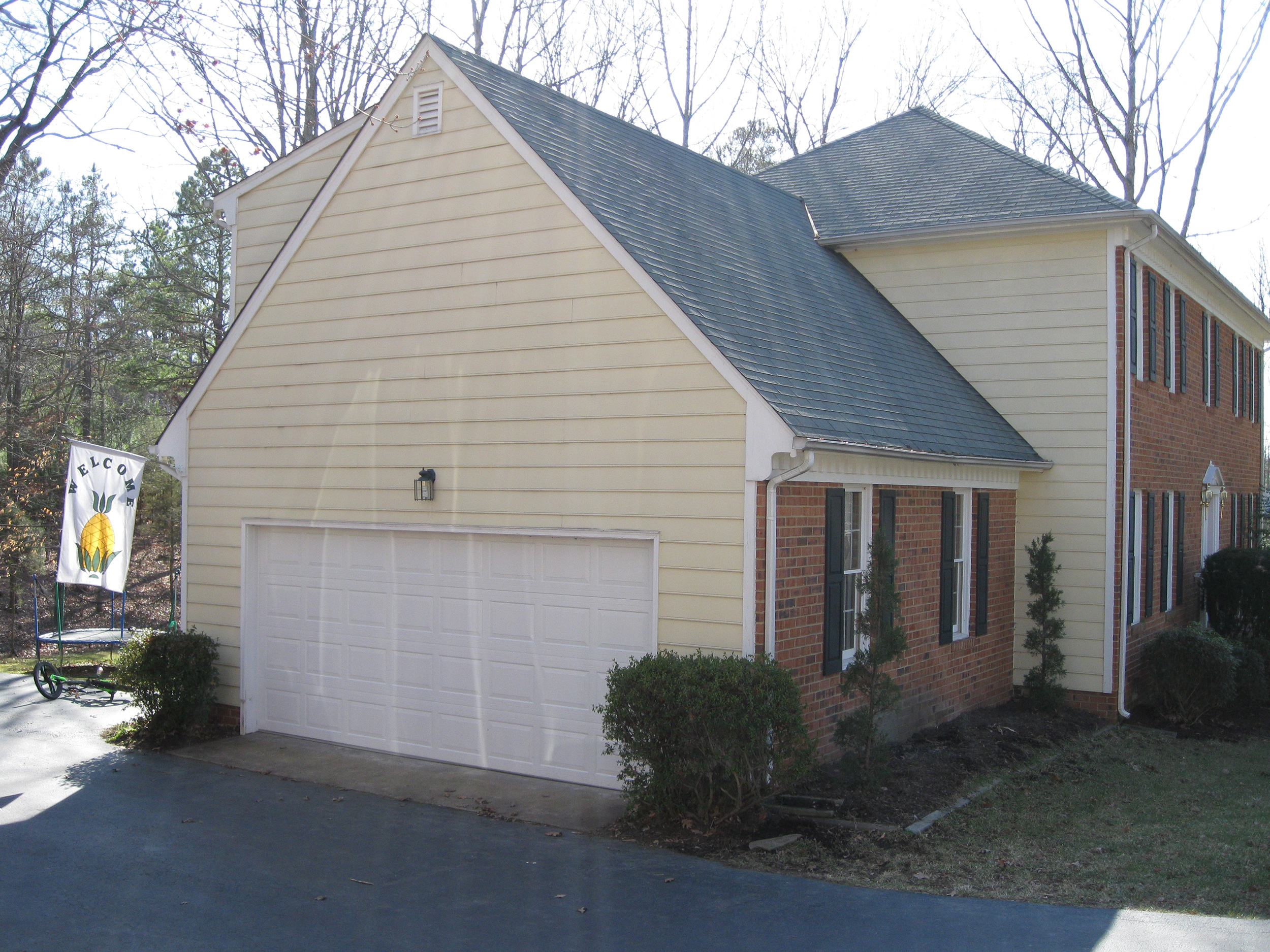 Attached two-car garage designed to match the home’s brick and siding exterior.