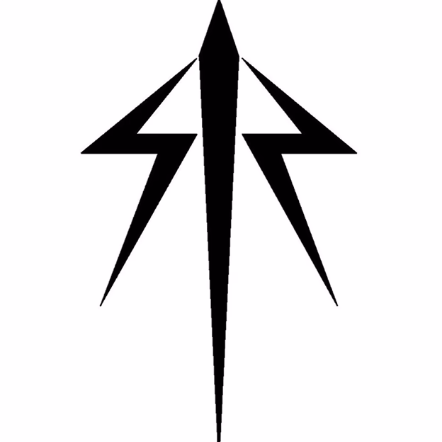 Smiling middle-aged man wearing a dark coat in a warmly lit indoor setting.